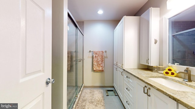 bathroom with walk in shower and vanity