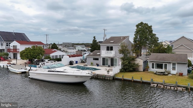 dock area featuring a lawn and a water view