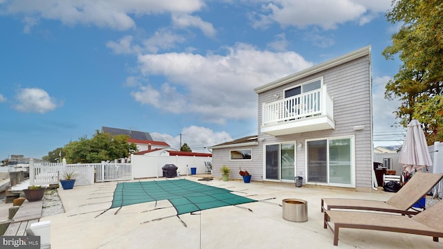 back of house with a patio area and a balcony