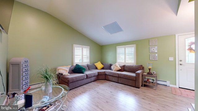 living room with vaulted ceiling, baseboard heating, and light hardwood / wood-style floors