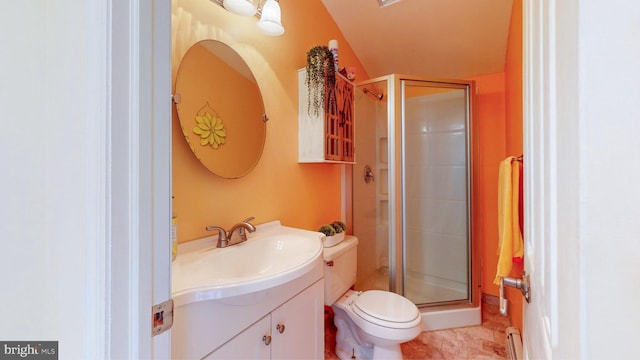 bathroom featuring vanity, a shower with shower door, and toilet