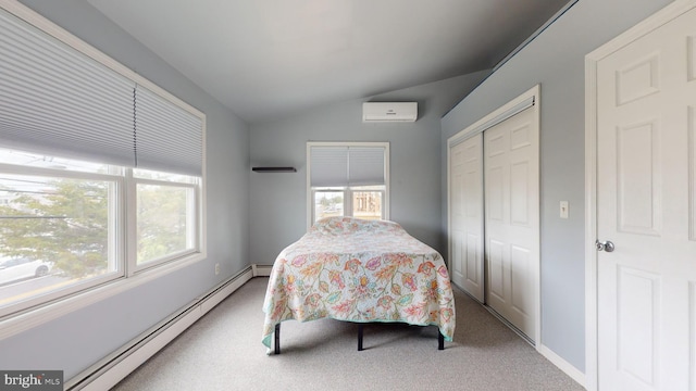 carpeted bedroom with lofted ceiling, a baseboard heating unit, a wall mounted air conditioner, and a closet