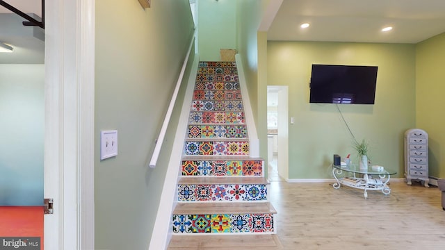 stairs featuring hardwood / wood-style flooring