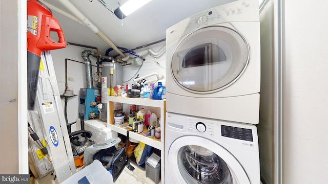 washroom featuring stacked washer and clothes dryer and water heater