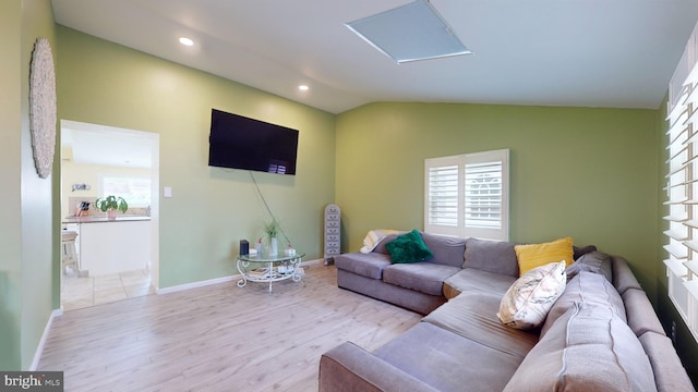 living room with lofted ceiling and light wood-type flooring