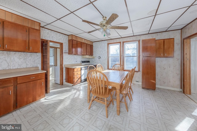 dining area featuring ceiling fan and a paneled ceiling