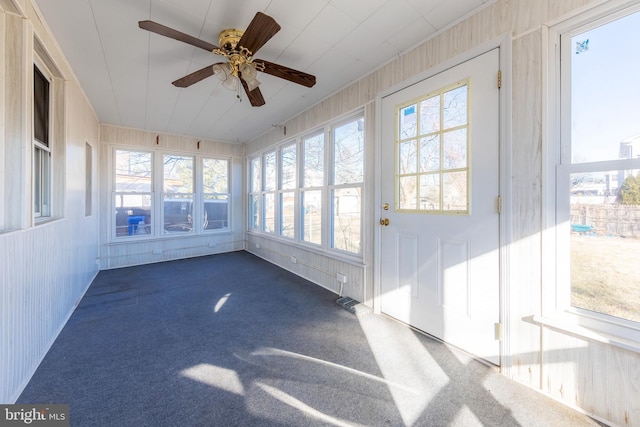 unfurnished sunroom with ceiling fan