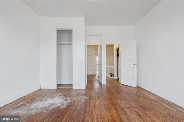 unfurnished bedroom featuring a closet and wood-type flooring