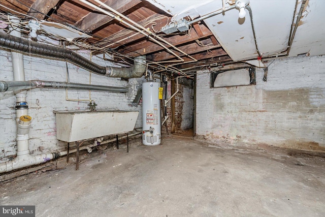 basement featuring water heater and sink