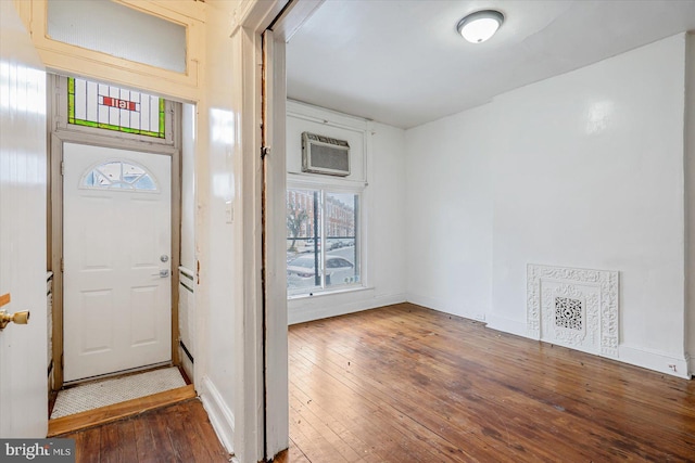 foyer with dark hardwood / wood-style flooring and a wall mounted AC