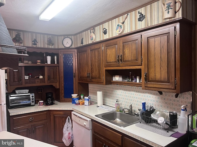 kitchen featuring tasteful backsplash, dark brown cabinets, sink, and white appliances