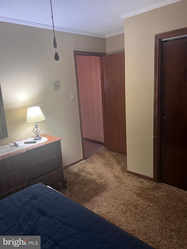 carpeted bedroom with crown molding and a textured ceiling