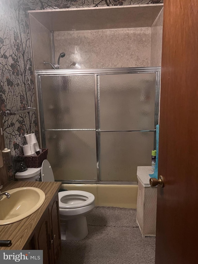 full bathroom featuring tile patterned floors, combined bath / shower with glass door, vanity, and toilet