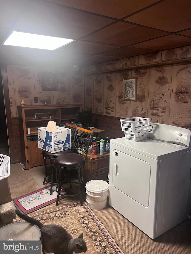 laundry room featuring washer / clothes dryer and wood walls