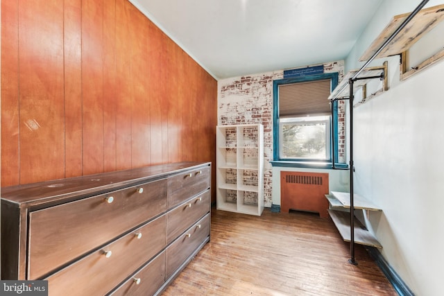 interior space featuring radiator heating unit and light hardwood / wood-style floors