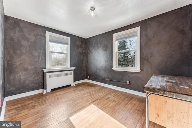 interior space with hardwood / wood-style flooring and radiator