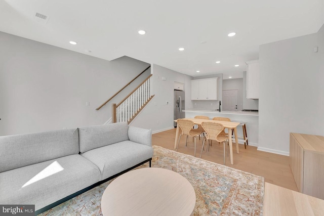 living room with sink and light hardwood / wood-style flooring