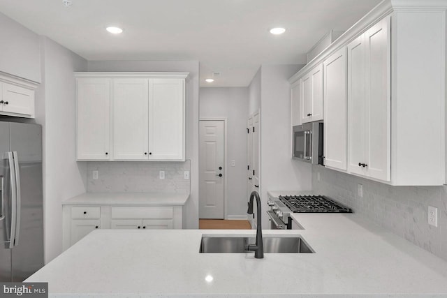 kitchen featuring sink, white cabinets, and appliances with stainless steel finishes