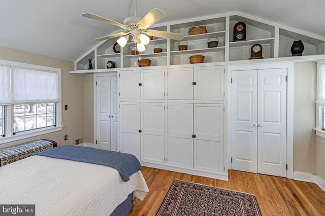 bedroom featuring lofted ceiling, light hardwood / wood-style flooring, and ceiling fan