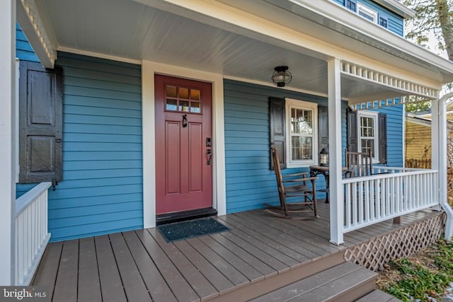 view of exterior entry with a porch