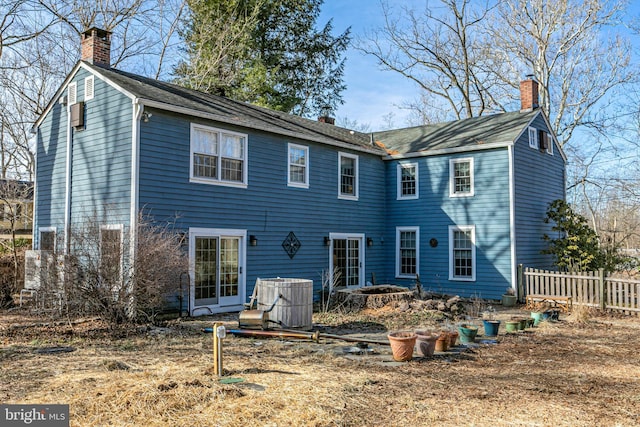 back of house with central AC