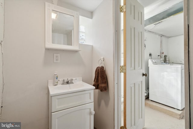 bathroom with vanity and washer / clothes dryer