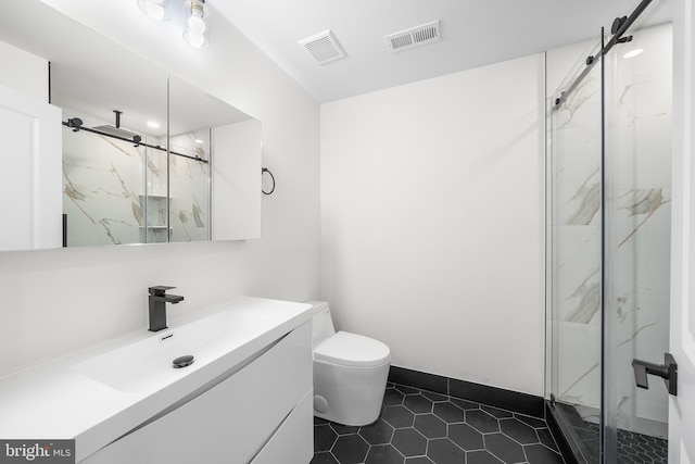 bathroom with a shower with door, tile patterned floors, vanity, and toilet