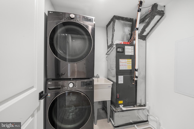 laundry area featuring stacked washing maching and dryer