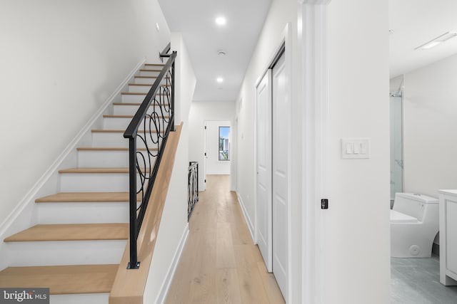 stairway with hardwood / wood-style flooring