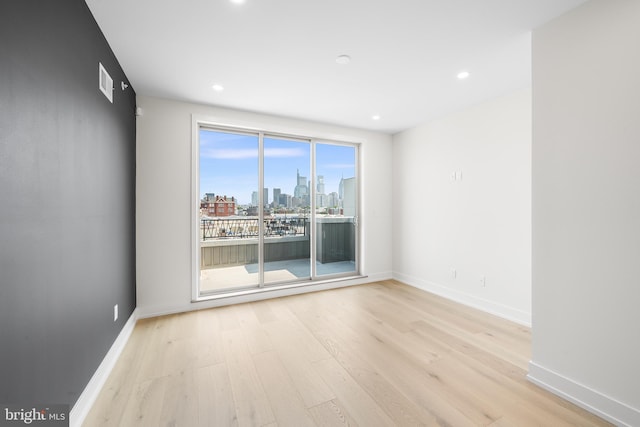 unfurnished room with light wood-type flooring