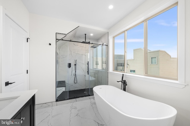 bathroom featuring separate shower and tub and vanity