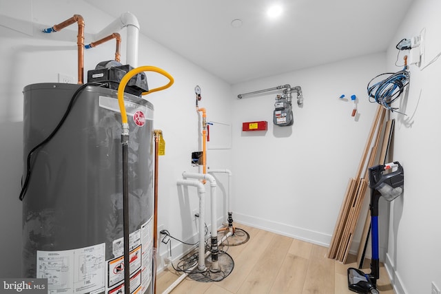 utility room featuring gas water heater