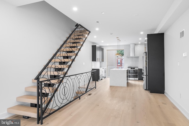 stairway featuring hardwood / wood-style flooring