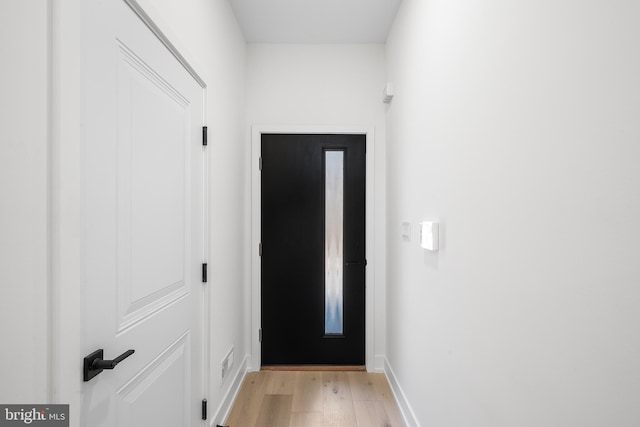 doorway to outside with light wood-type flooring