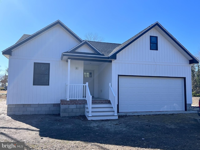 view of front of house with a garage and a shingled roof