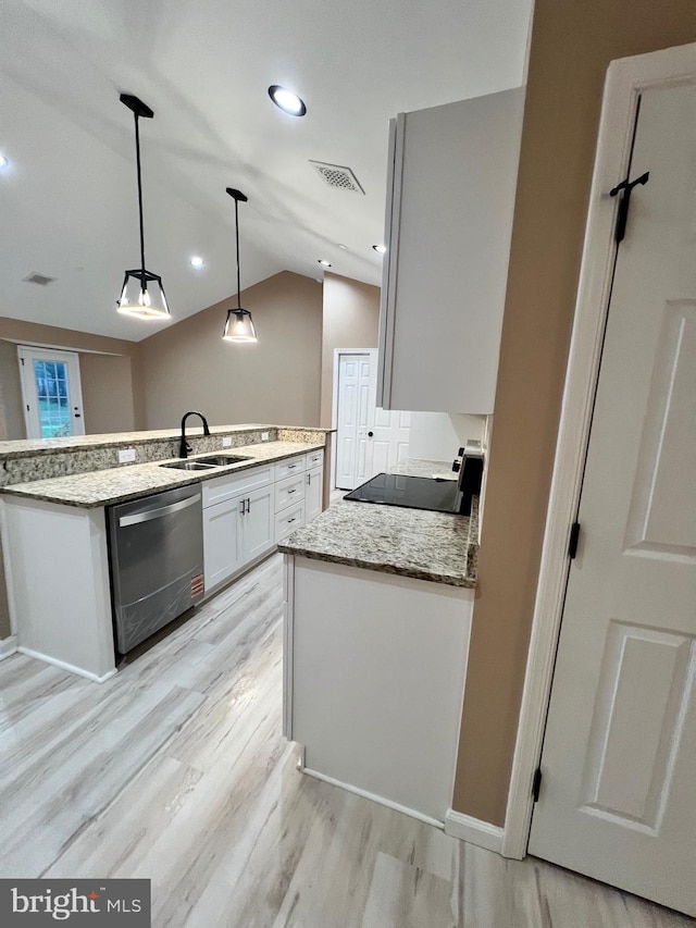 kitchen featuring visible vents, hanging light fixtures, dishwasher, a sink, and light wood-style floors