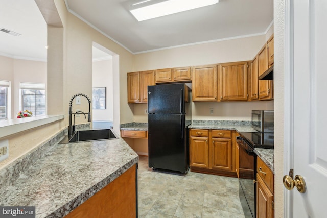 kitchen with black appliances, range hood, crown molding, and sink