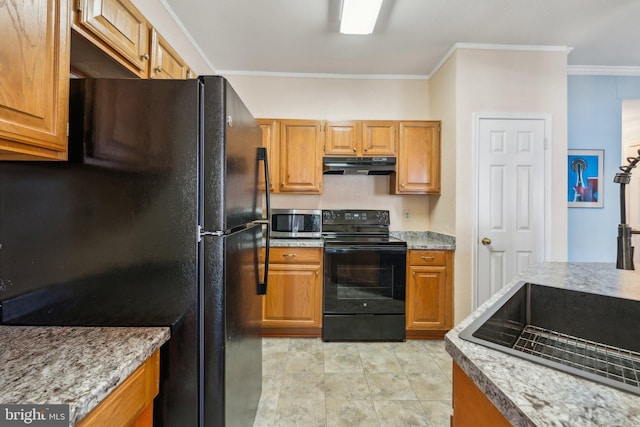 kitchen with sink, ornamental molding, and black appliances