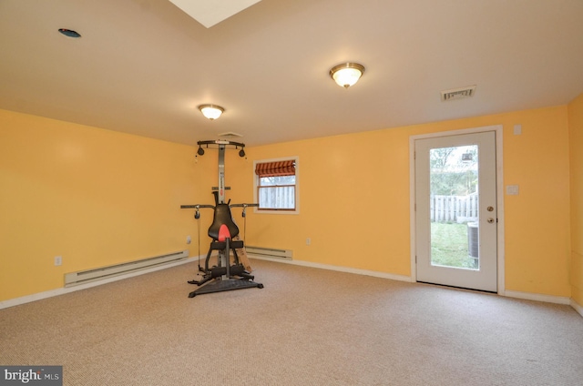 exercise room with a baseboard radiator and carpet