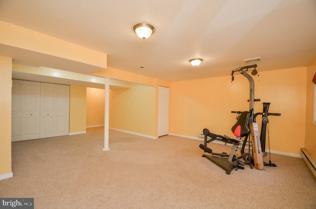 workout area with a baseboard radiator and light colored carpet