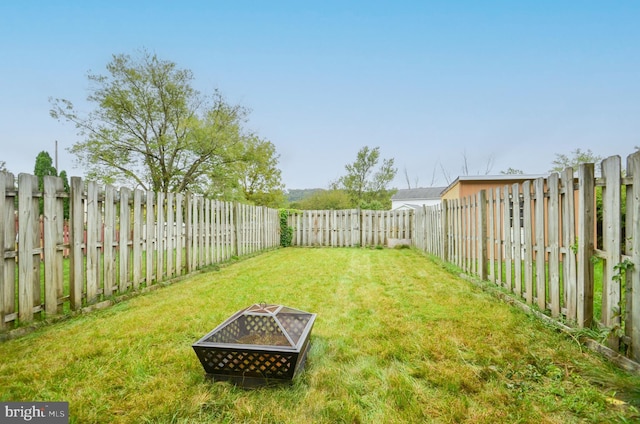 view of yard with an outdoor fire pit