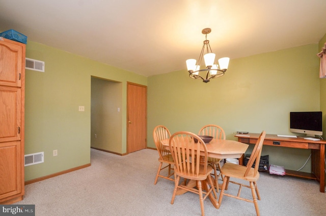 dining room featuring light carpet and a chandelier