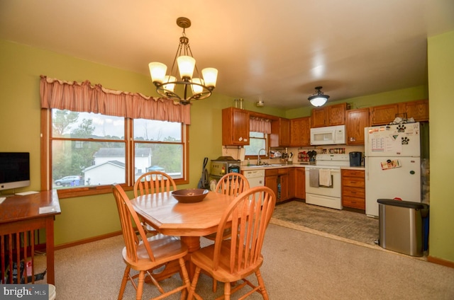 carpeted dining space with a chandelier and sink