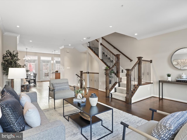 living room with an inviting chandelier, crown molding, and wood-type flooring