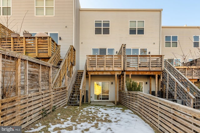 snow covered property featuring a deck