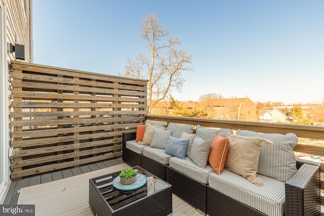 wooden balcony featuring an outdoor living space and a deck