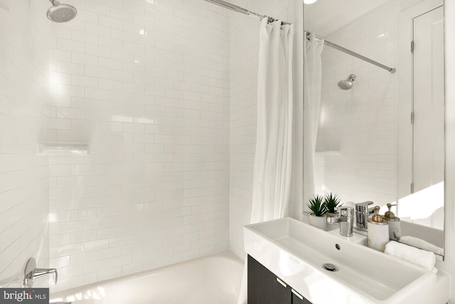 bathroom featuring shower / bathtub combination with curtain and vanity