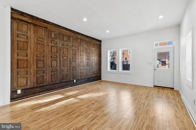 spare room with light hardwood / wood-style flooring and a wealth of natural light