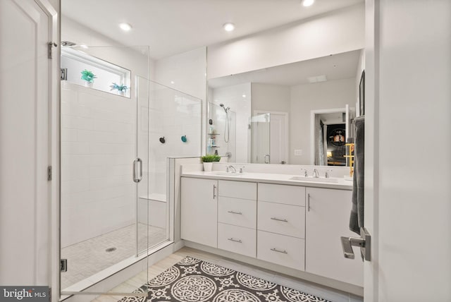 bathroom with walk in shower, vanity, and tile patterned flooring