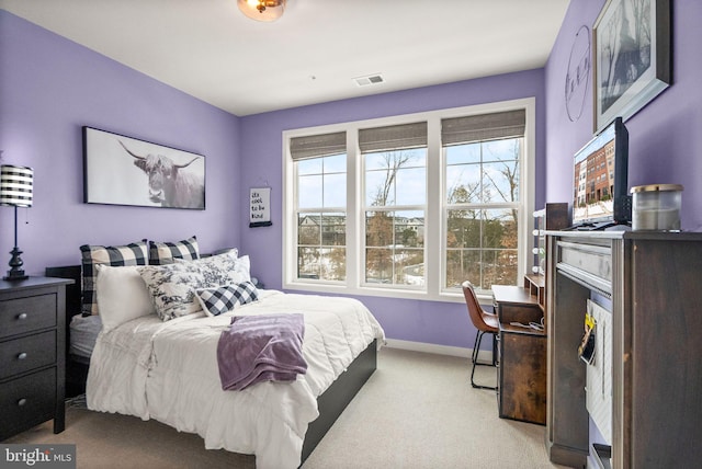 carpeted bedroom featuring multiple windows